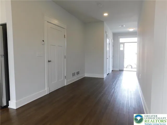 a view of hallway with wooden floor