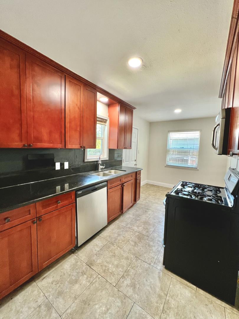 3689 McClellan Drive North Highlands, CA 95660 - Photo 13 of 20 a kitchen with stainless steel appliances granite countertop a stove a sink and a microwave