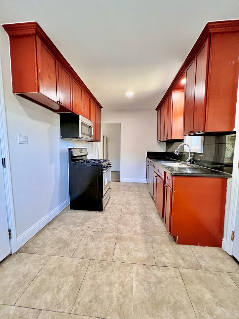 3689 McClellan Drive North Highlands, CA 95660 - Photo 15 of 20 a kitchen with stainless steel appliances granite countertop a stove sink and cabinets