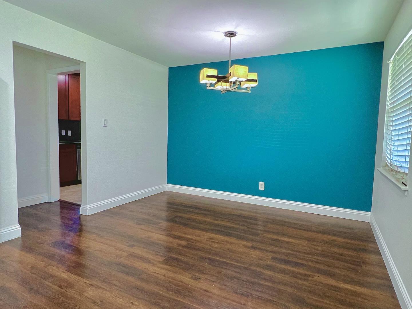 3689 McClellan Drive North Highlands, CA 95660 - Photo 4 of 20 an empty room with wooden floor and chandelier