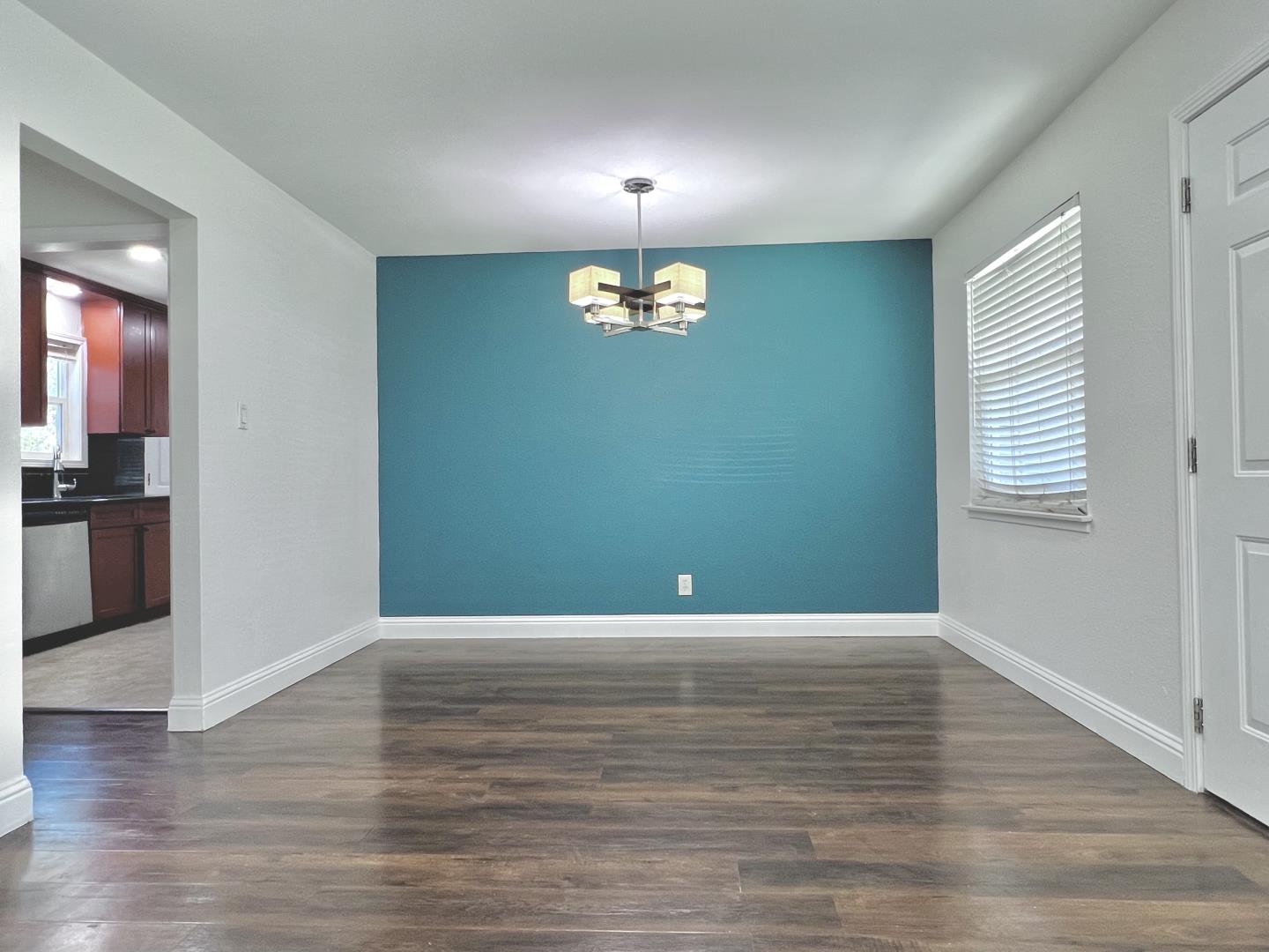 3689 McClellan Drive North Highlands, CA 95660 - Photo 6 of 20 a view of an empty room with window and wooden floor