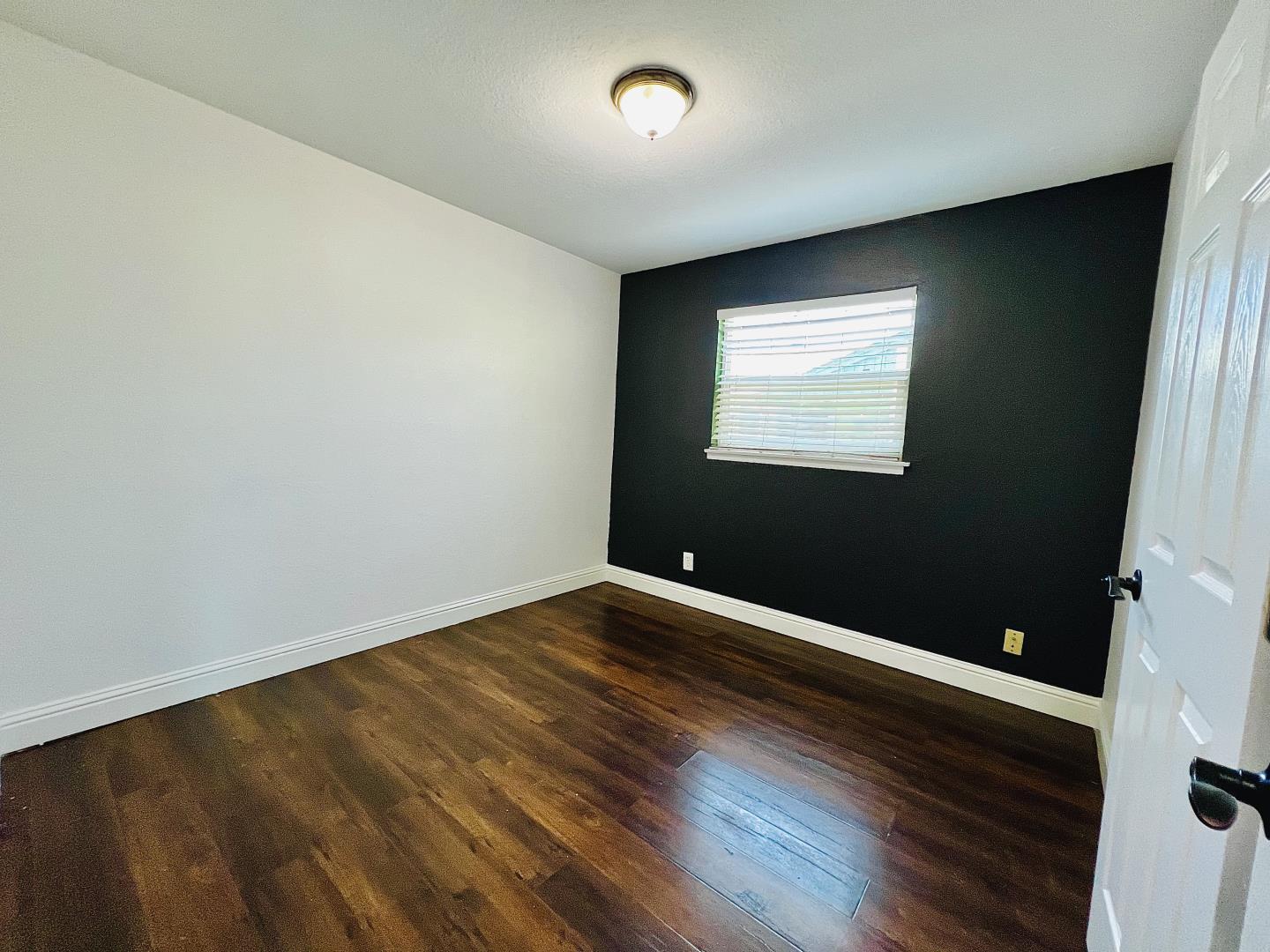 3689 McClellan Drive North Highlands, CA 95660 - Photo 9 of 20 an empty room with wooden floor and windows