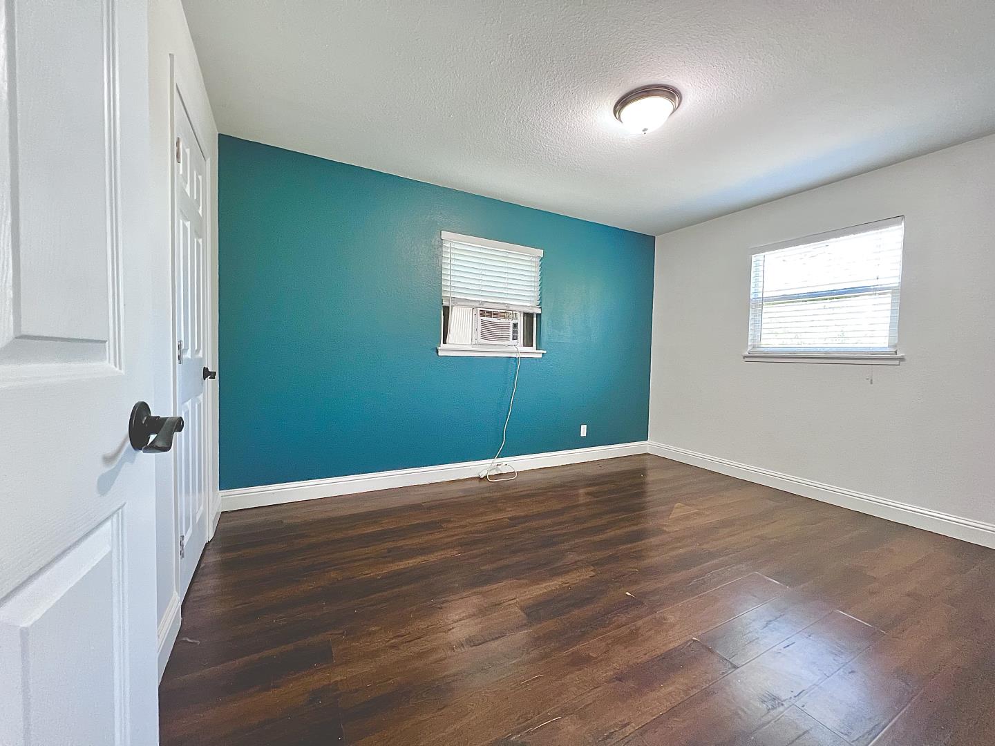 3689 McClellan Drive North Highlands, CA 95660 - Photo 10 of 20 an empty room with wooden floor and windows