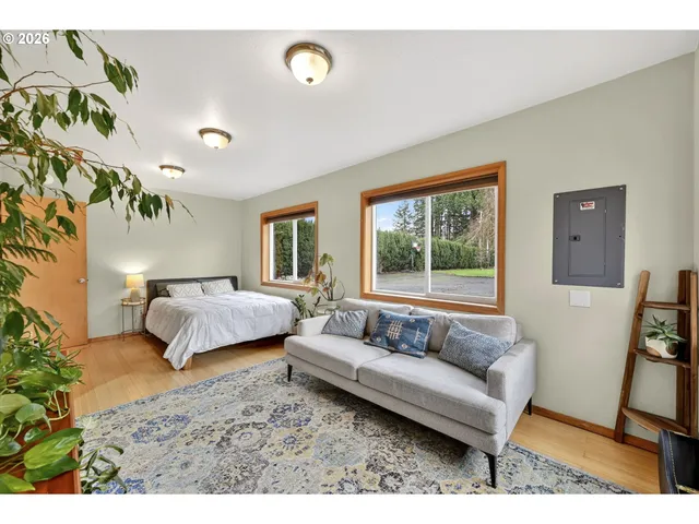 a bedroom with a bed couch and a window