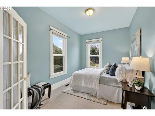 a bedroom with bed and a window