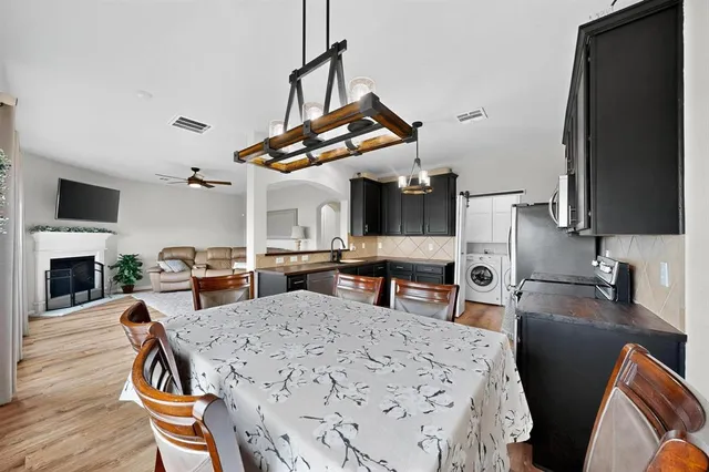 a kitchen with stainless steel appliances granite countertop a stove and a refrigerator
