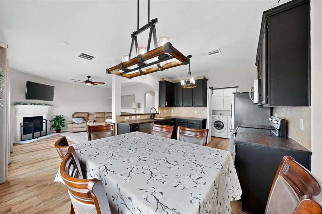 2820 Appaloosa Court Little Elm, TX 75068 - Photo 11 of 40 a living room with furniture a fireplace and a flat screen tv