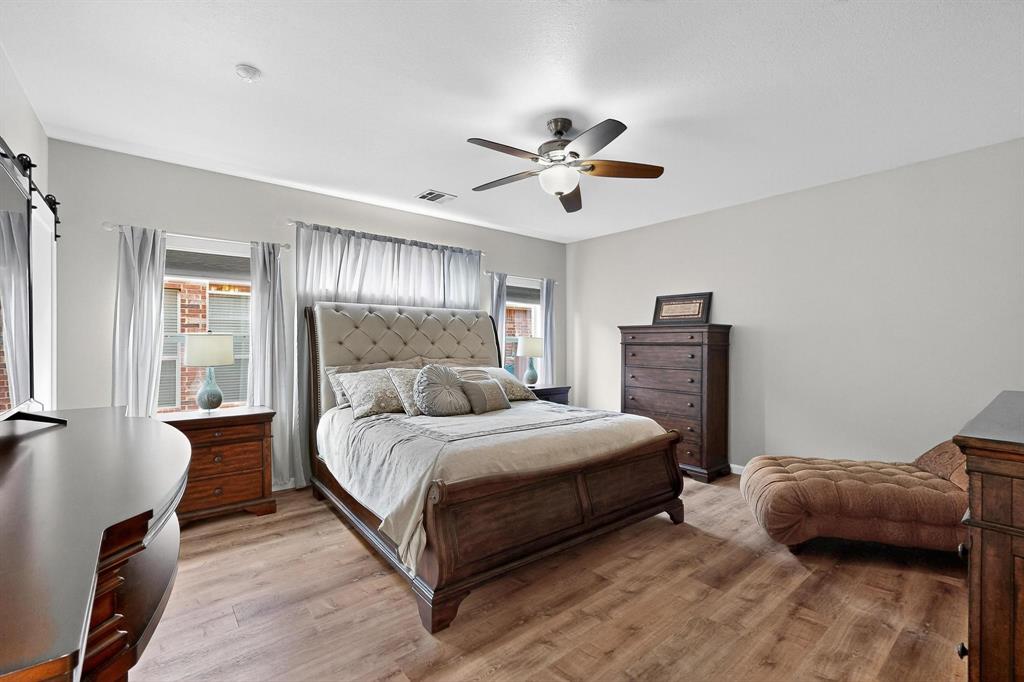 2820 Appaloosa Court Little Elm, TX 75068 - Photo 13 of 40 a bedroom with a bed ceiling fan and a window