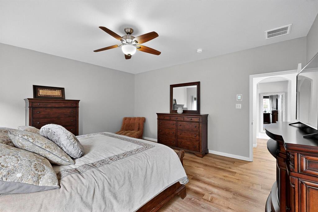 2820 Appaloosa Court Little Elm, TX 75068 - Photo 15 of 40 a bedroom with a bed and wooden floor