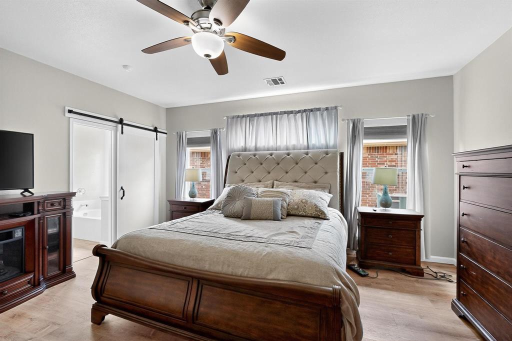 2820 Appaloosa Court Little Elm, TX 75068 - Photo 16 of 40 a bedroom with a bed and a walk in closet