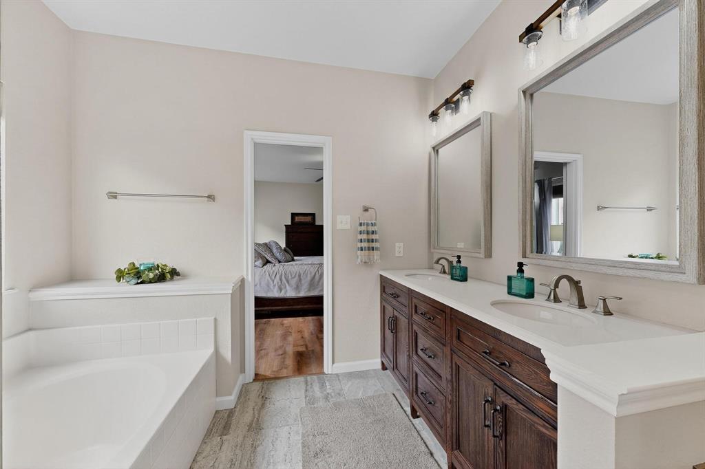 2820 Appaloosa Court Little Elm, TX 75068 - Photo 17 of 40 a spacious bathroom with a double vanity sink mirror and bathtub