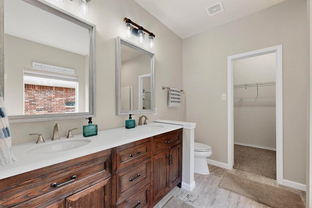 2820 Appaloosa Court Little Elm, TX 75068 - Photo 18 of 40 a bathroom with a granite countertop sink mirror and toilet