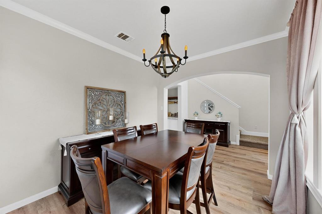 2820 Appaloosa Court Little Elm, TX 75068 - Photo 21 of 40 a view of a dining room with furniture and wooden floor