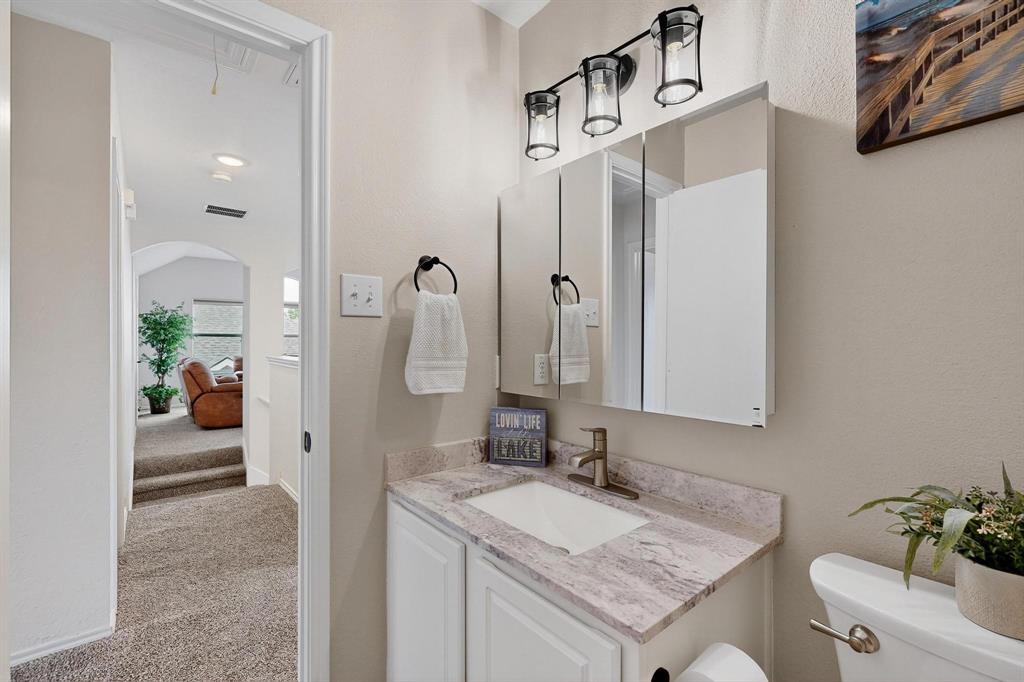 2820 Appaloosa Court Little Elm, TX 75068 - Photo 25 of 40 a bathroom with a sink and a mirror