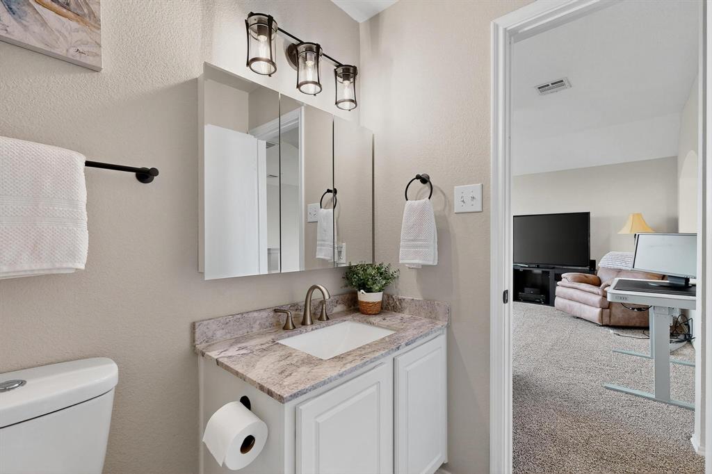 2820 Appaloosa Court Little Elm, TX 75068 - Photo 29 of 40 a view of bathroom with a sink and a mirror