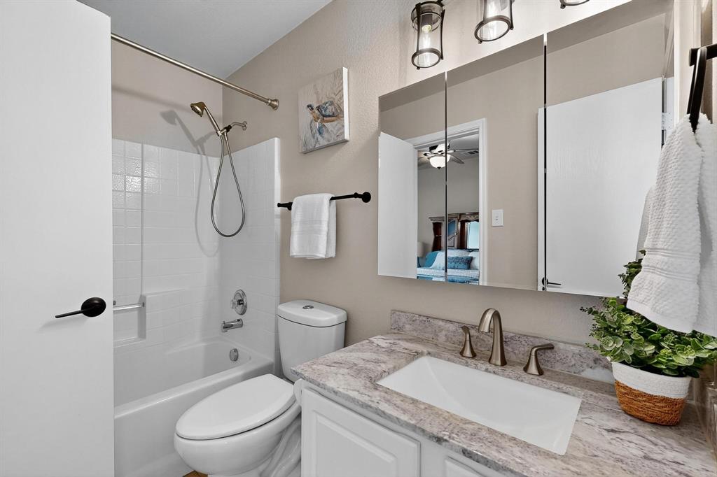 2820 Appaloosa Court Little Elm, TX 75068 - Photo 30 of 40 a bathroom with a granite countertop sink toilet and shower