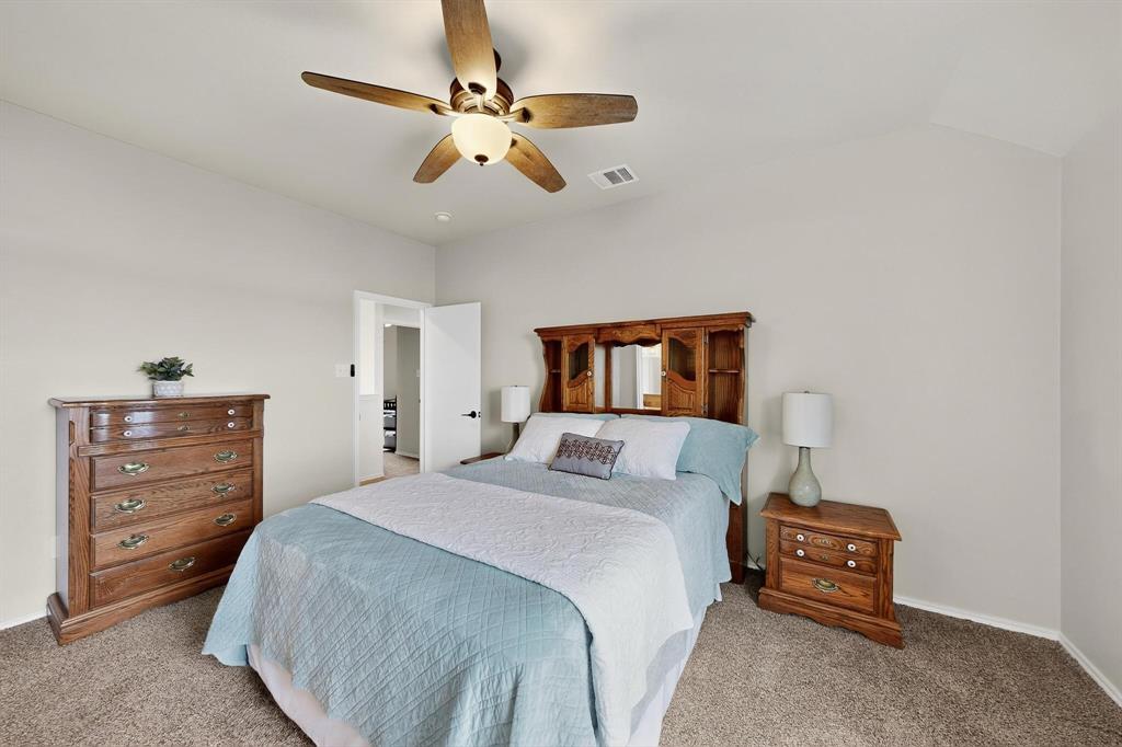 2820 Appaloosa Court Little Elm, TX 75068 - Photo 32 of 40 a bedroom with a bed and a dresser