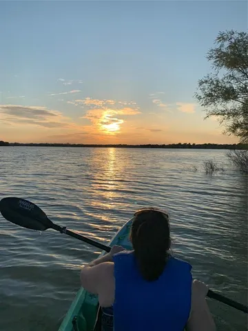 a view of roof deck with wooden floor and lake view