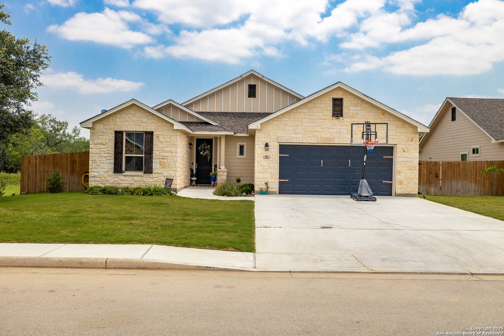 218 Iron Gate Pleasanton, TX 78064 - Photo 1 of 15 a front view of a house with a yard and garage