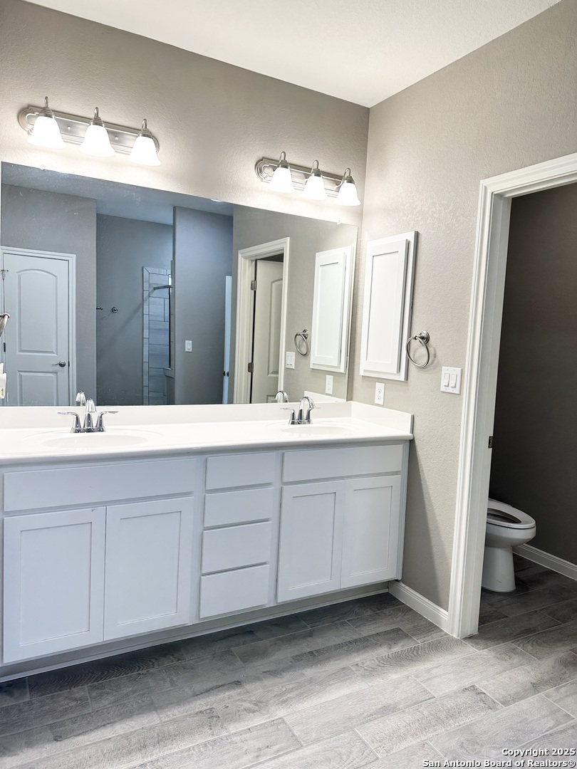 218 Iron Gate Pleasanton, TX 78064 - Photo 11 of 15 a bathroom with a double vanity sink and a mirror