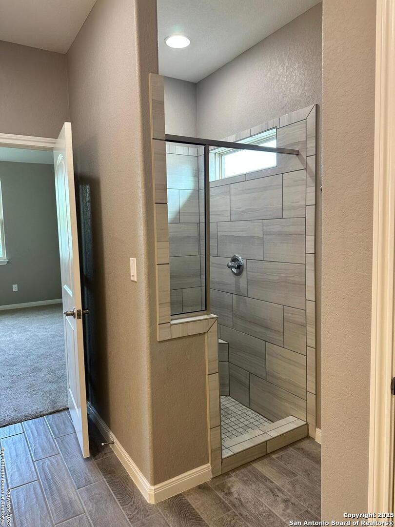 218 Iron Gate Pleasanton, TX 78064 - Photo 12 of 15 a bathroom with a glass shower door