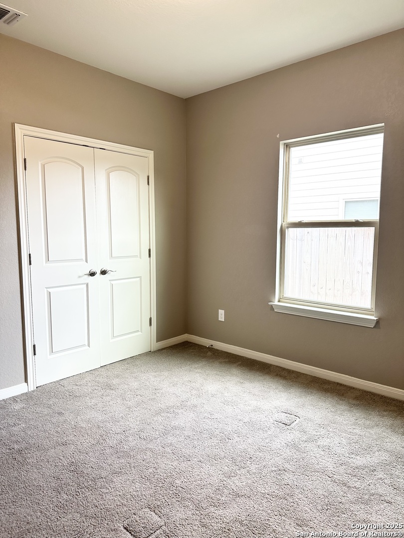218 Iron Gate Pleasanton, TX 78064 - Photo 4 of 15 an empty room with a window