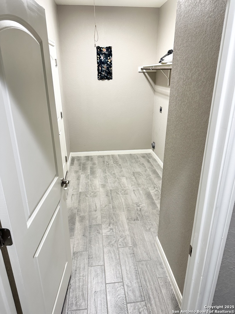 218 Iron Gate Pleasanton, TX 78064 - Photo 5 of 15 a view of room with wooden floor and staircase
