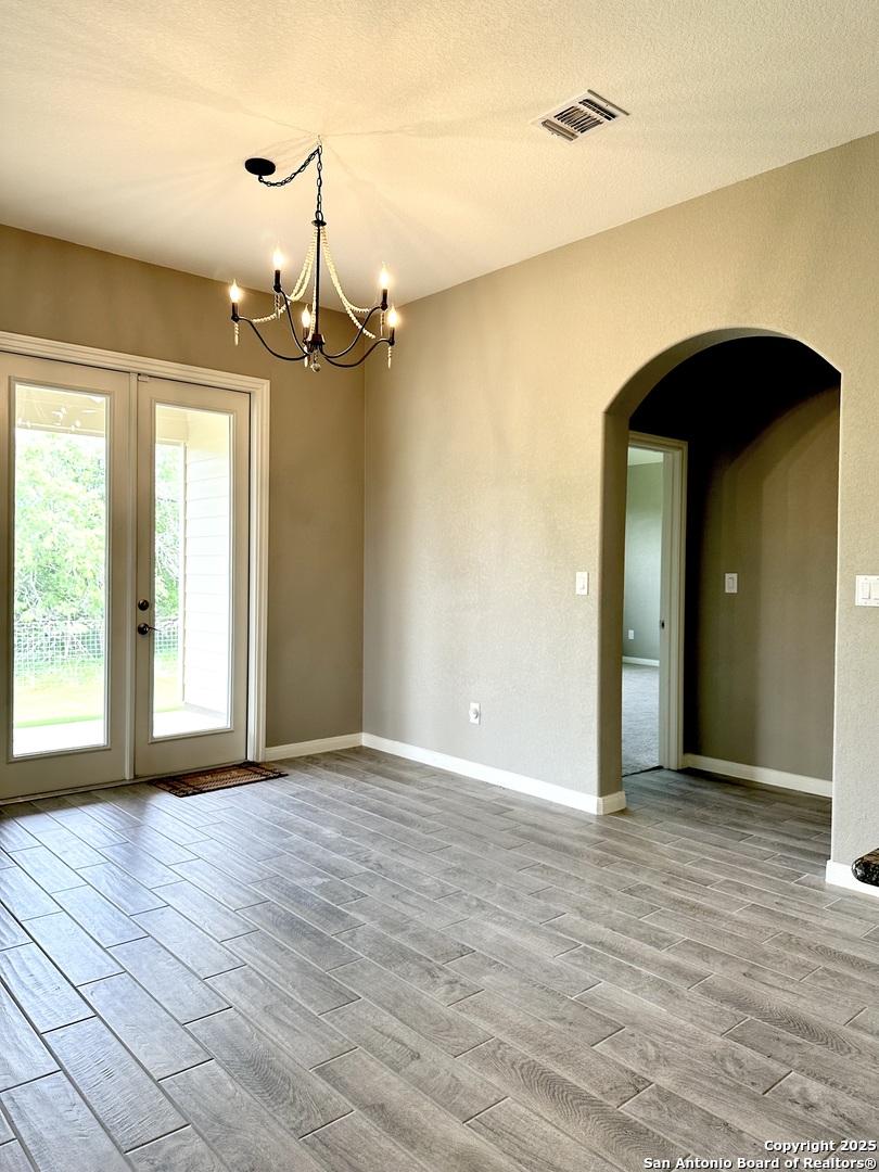 218 Iron Gate Pleasanton, TX 78064 - Photo 8 of 15 a view of a room with wooden floor and windows