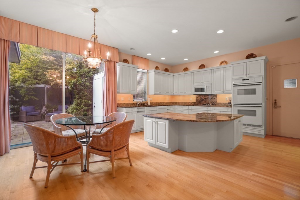 64 Highland Street Cambridge, MA 02138 - Photo 17 of 41 a kitchen with stainless steel appliances granite countertop a stove top oven a sink and a refrigerator