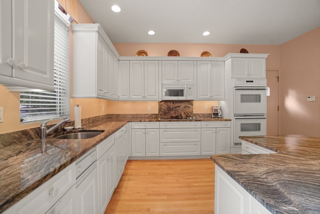 64 Highland Street Cambridge, MA 02138 - Photo 18 of 41 a large kitchen with granite countertop a sink and white appliances