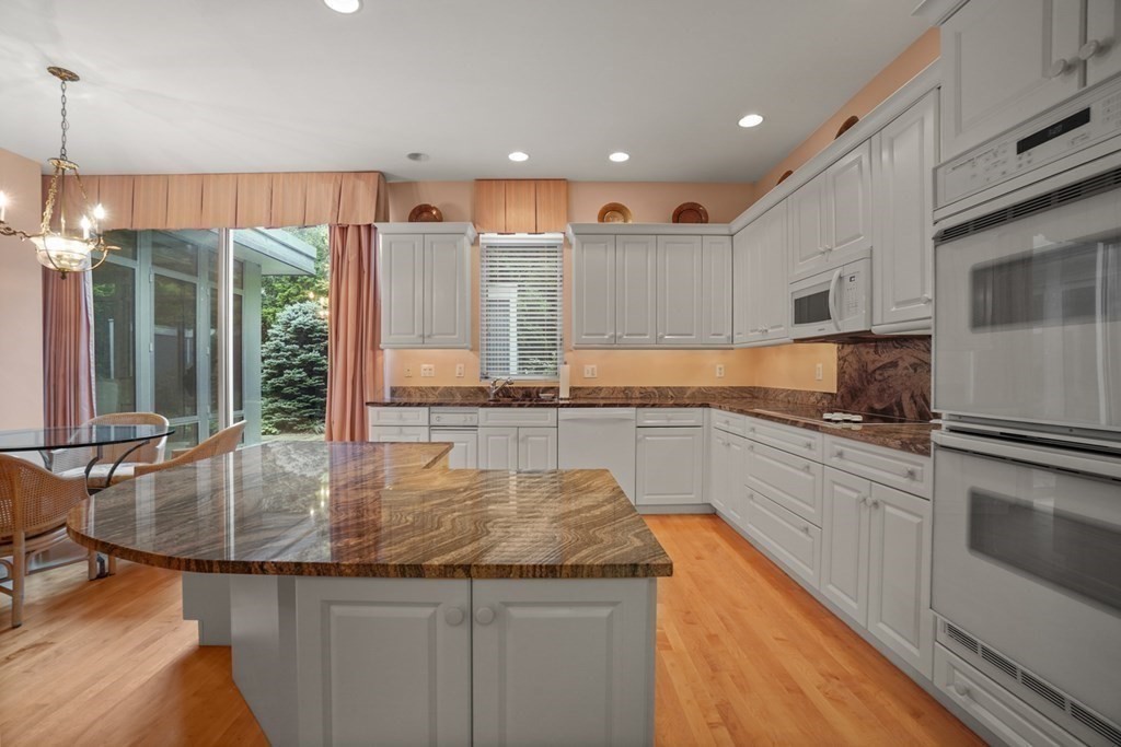 64 Highland Street Cambridge, MA 02138 - Photo 20 of 41 a kitchen with kitchen island granite countertop a stove and a sink