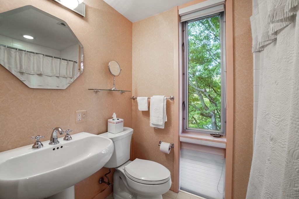 64 Highland Street Cambridge, MA 02138 - Photo 30 of 41 a bathroom with a sink toilet and a mirror