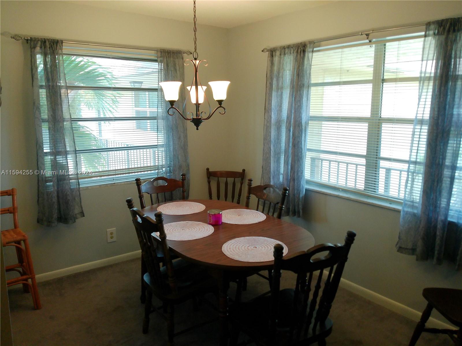 1100 East Indiantown Road, Unit 110 Jupiter, FL 33477 - Photo 5 of 19 a view of a dining room with furniture window and outside view
