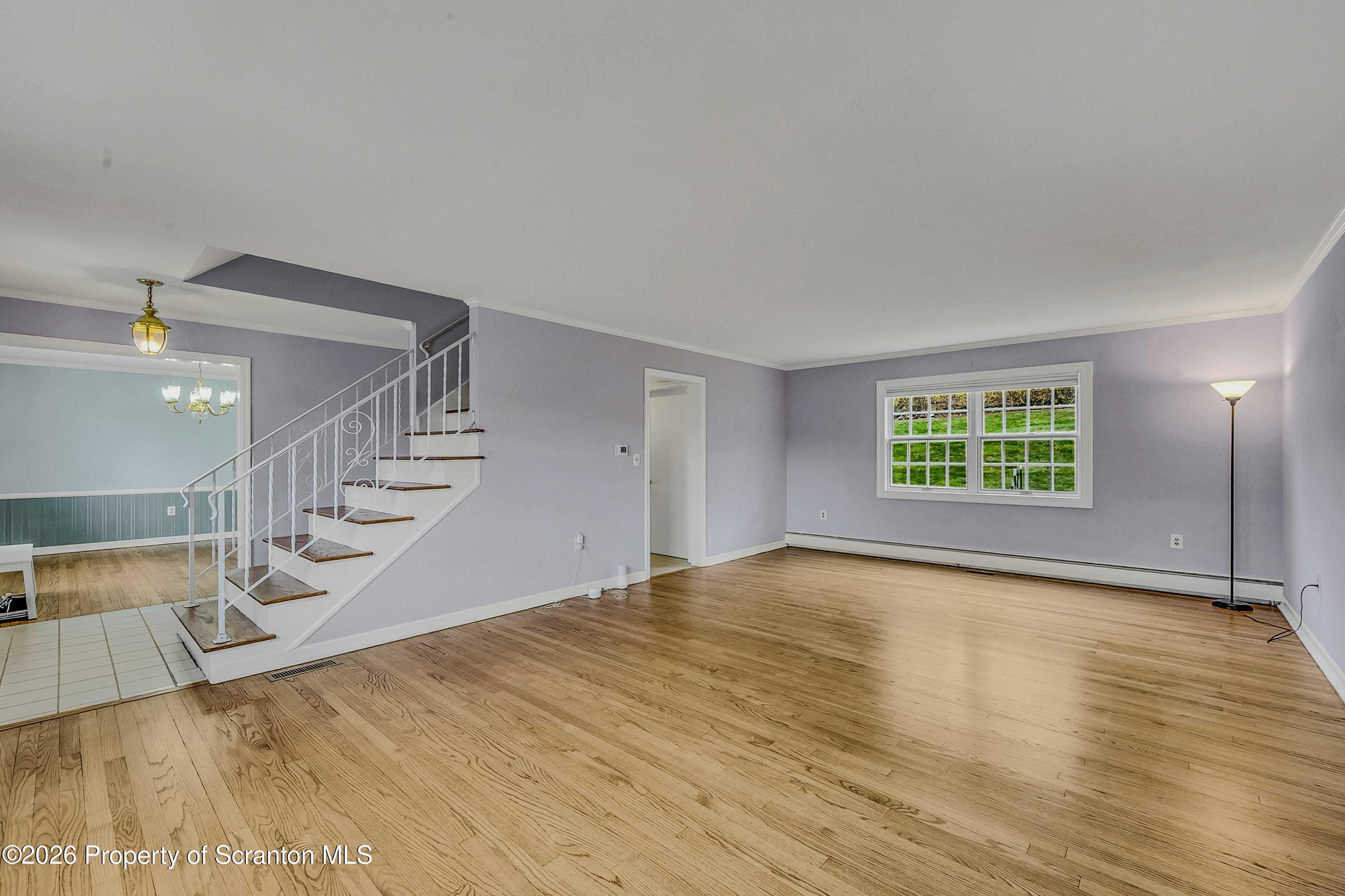 108 Sturbridge Road Clarks Summit, PA 18411 - Photo 20 of 67 a view of an empty room with wooden floor and a window