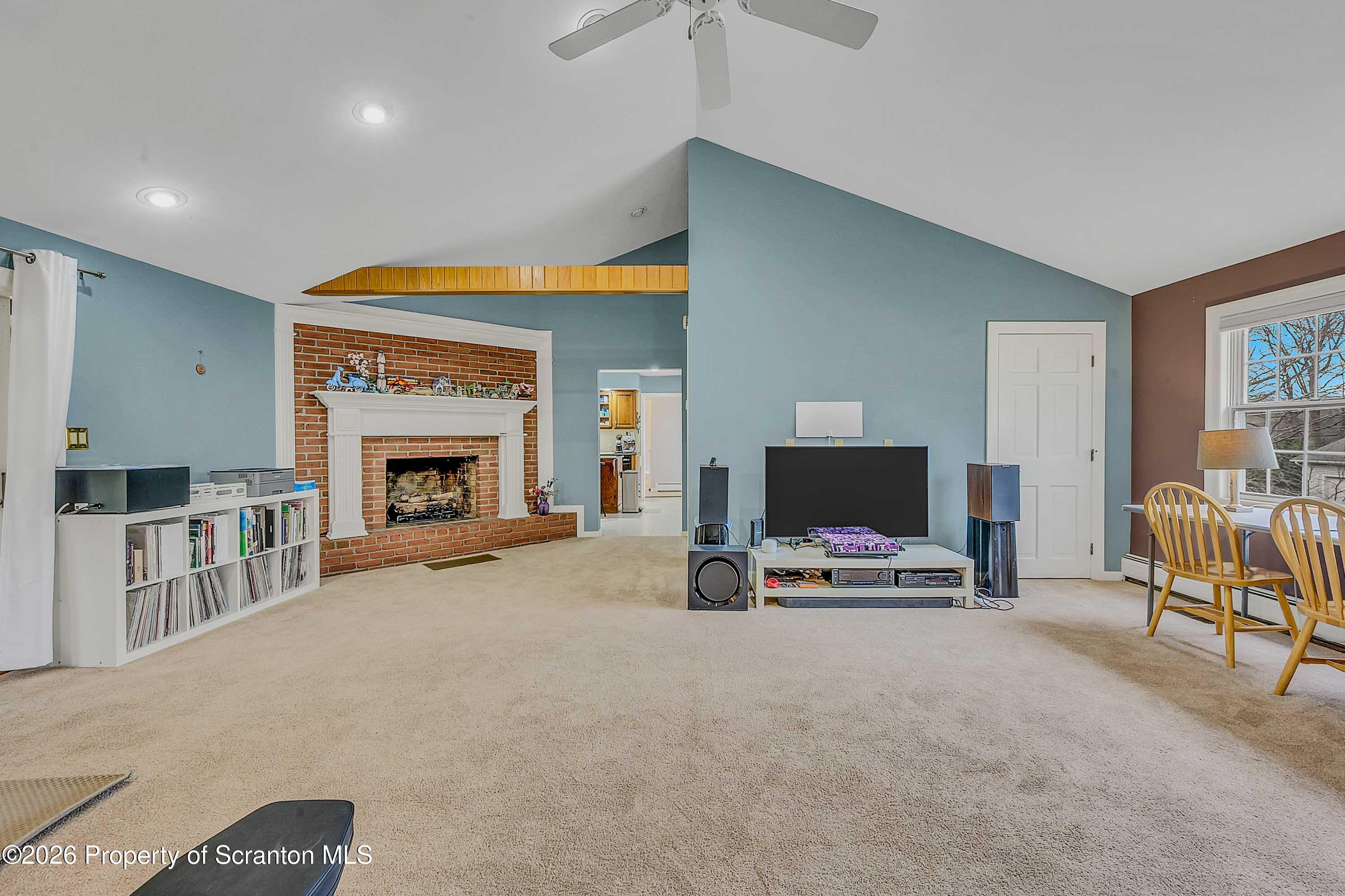 108 Sturbridge Road Clarks Summit, PA 18411 - Photo 26 of 67 a living room with furniture a fireplace and a flat screen tv