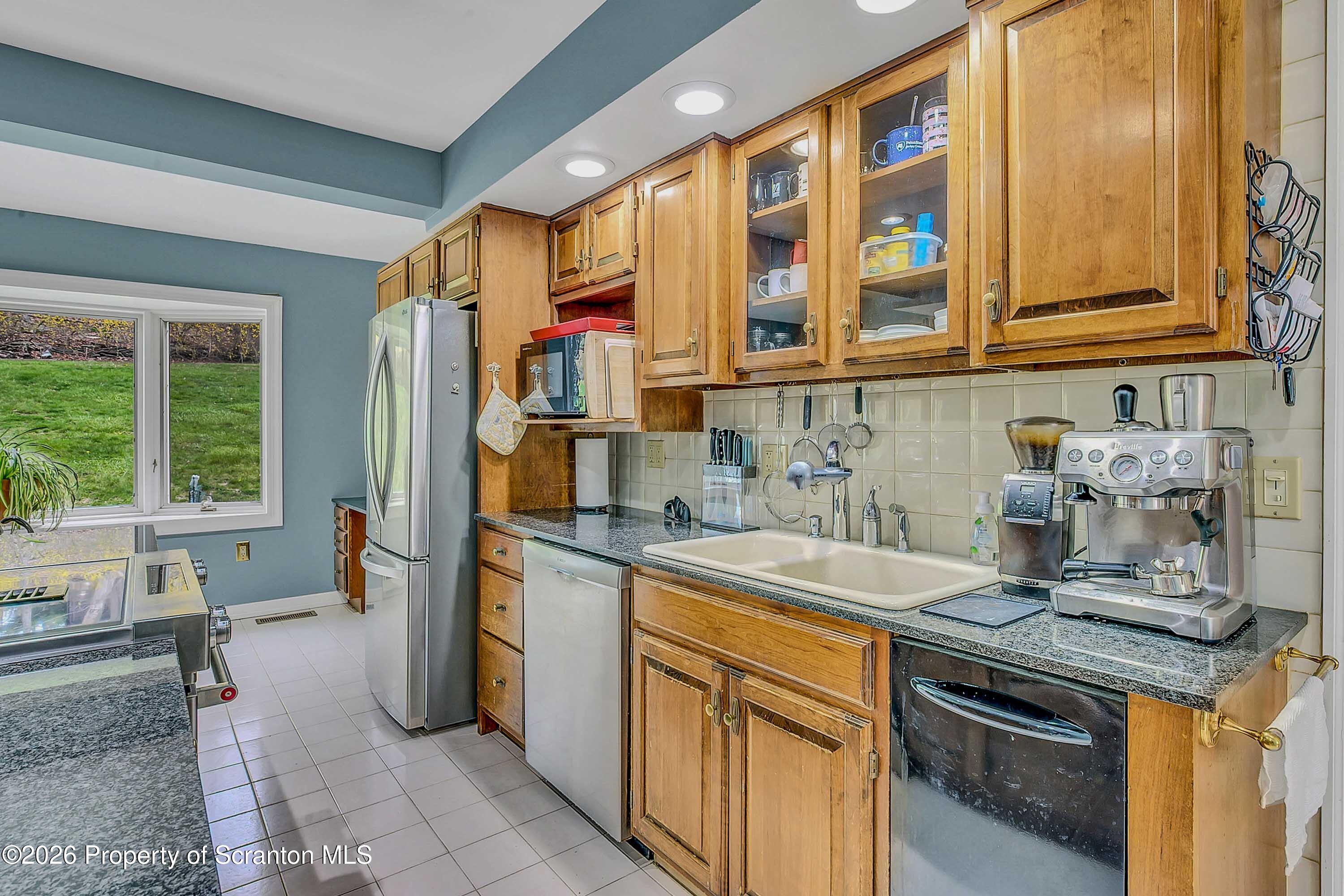 108 Sturbridge Road Clarks Summit, PA 18411 - Photo 35 of 67 a kitchen with a sink stove and cabinets