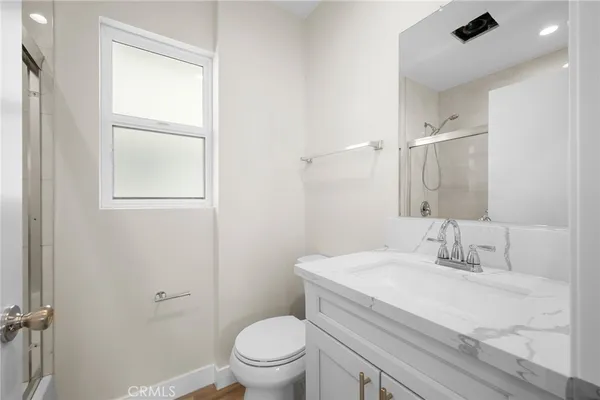 a bathroom with a sink toilet and vanity