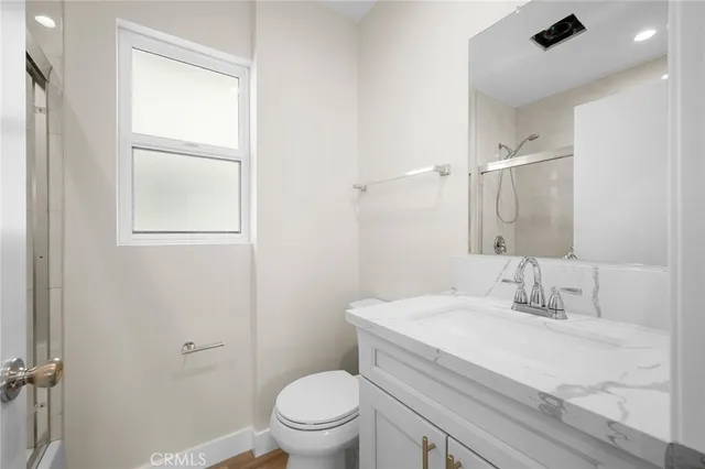 a bathroom with a sink toilet and vanity