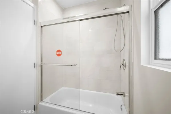 a bathroom with a shower and a shower