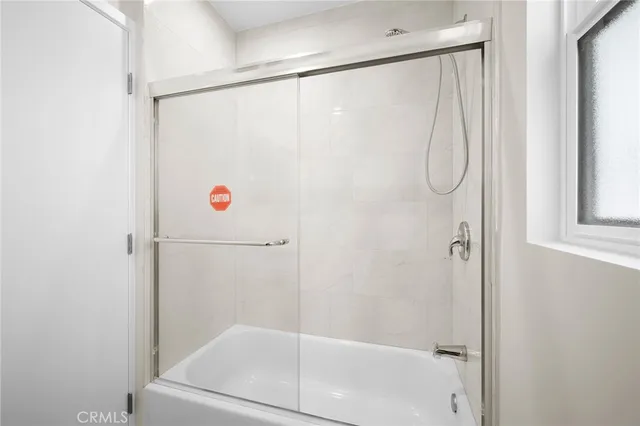 a bathroom with a shower and a shower