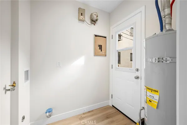 a view of hallway with stairs and wooden floor