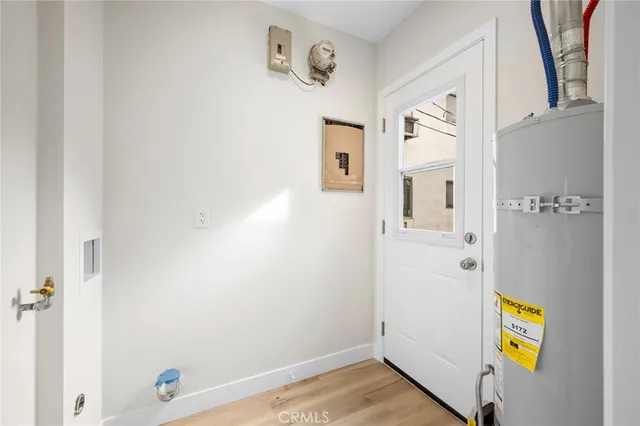 a view of hallway with stairs and wooden floor