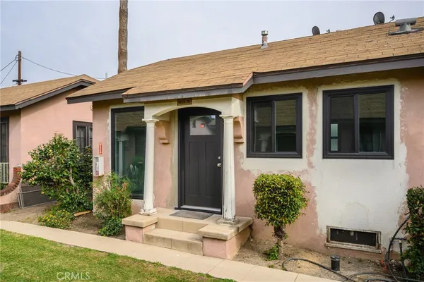 a front view of a house with potted plants