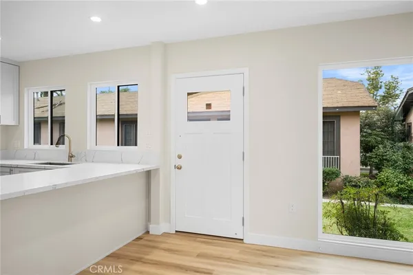 a view of a kitchen with a sink wooden floor and a kitchen space