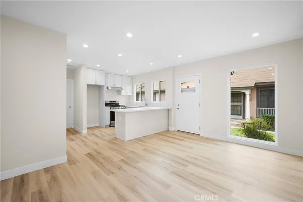 a view of kitchen with wooden cabinet and refrigerator