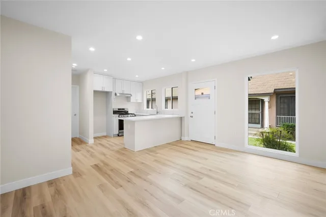 a view of kitchen with wooden cabinet and refrigerator