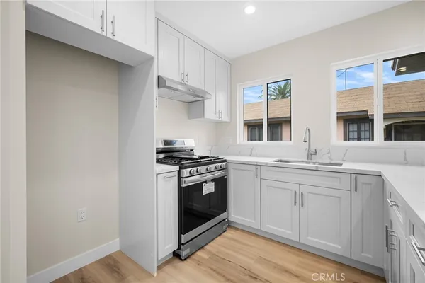 a kitchen with stainless steel appliances granite countertop a stove and a sink