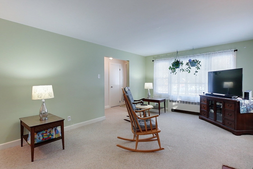 19 Mill Road Littleton, MA 01460 - Photo 12 of 31 a living room with furniture and a flat screen tv