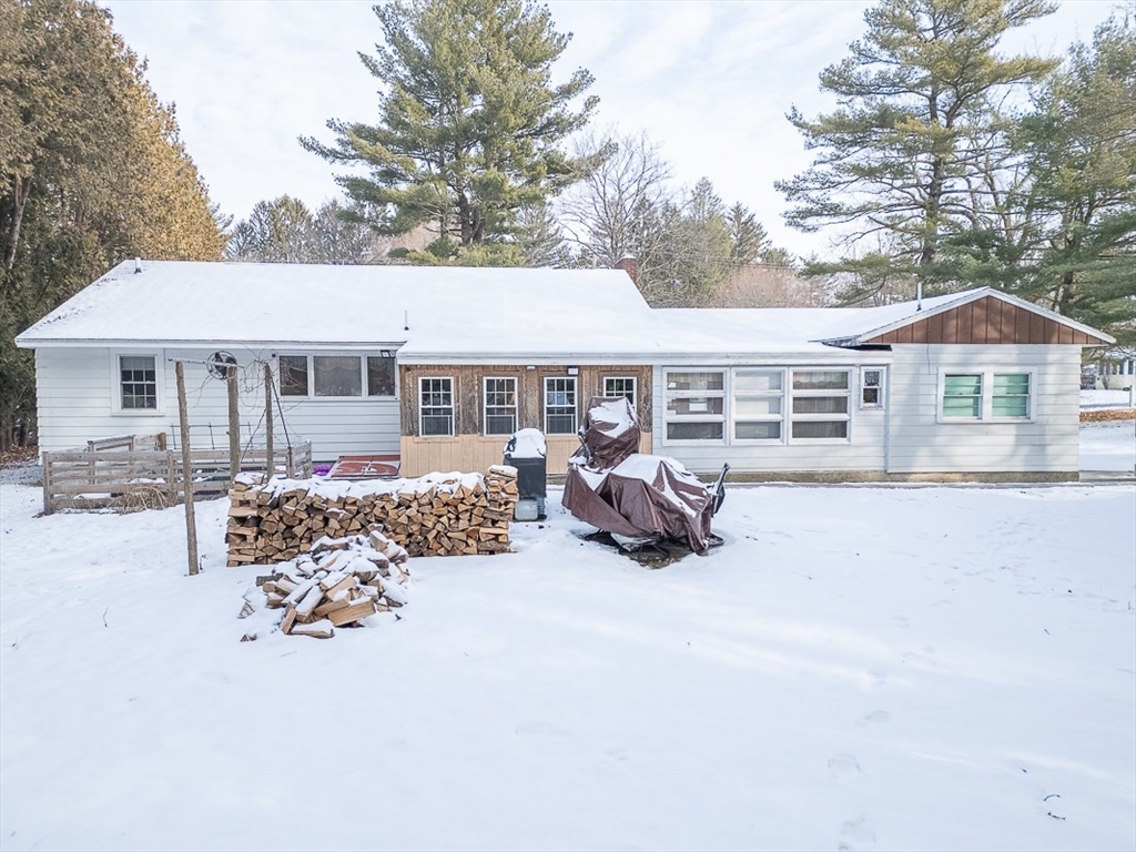 19 Mill Road Littleton, MA 01460 - Photo 2 of 31 a front view of a house with a patio outdoor seating and covered with trees