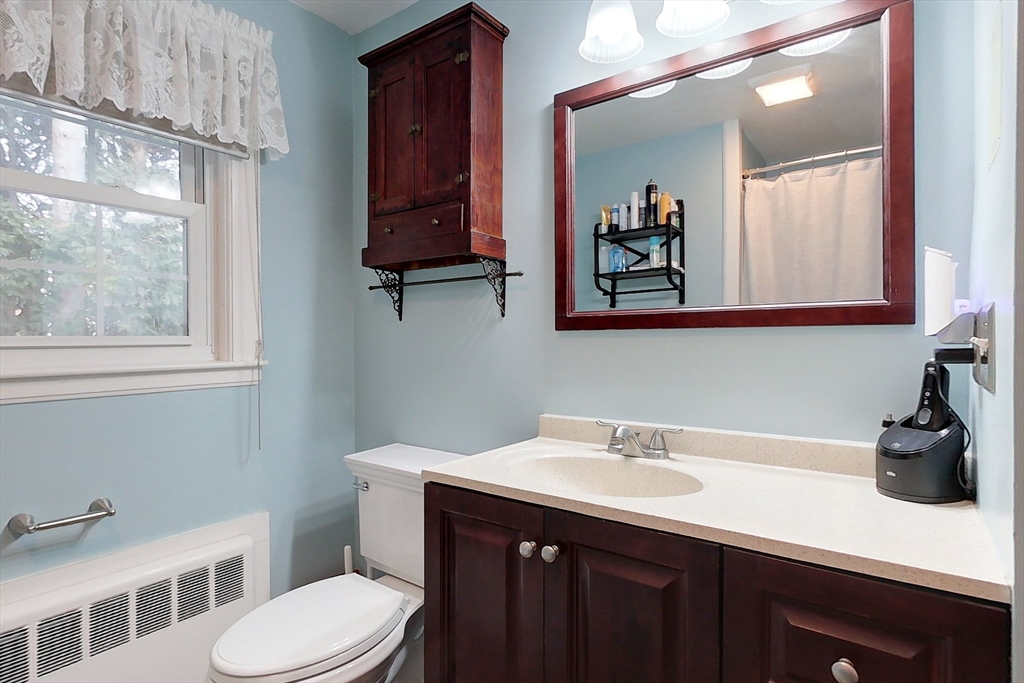 19 Mill Road Littleton, MA 01460 - Photo 22 of 31 a bathroom with a sink a toilet and mirror